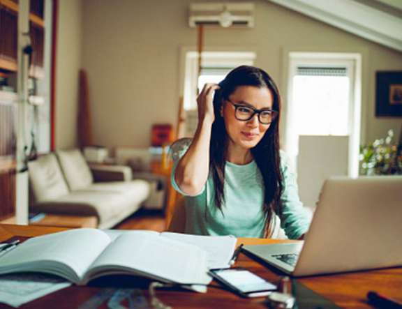 A woman participates in training from her home office